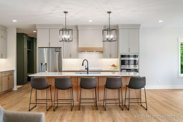 12607 76th Ave, Allendale, MI 49401 - kitchen featuring appliances with stainless steel finishes, a chandelier, a sink, decorative backsplash, and recessed lighting