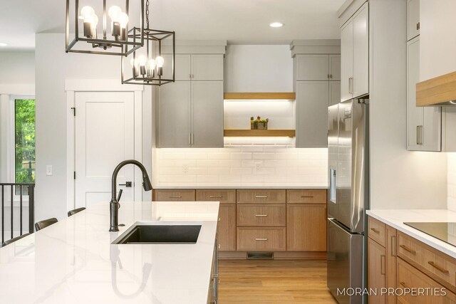 12607 76th Ave, Allendale, MI 49401 - kitchen with stainless steel fridge with ice dispenser, a sink, open shelves, backsplash, and a chandelier