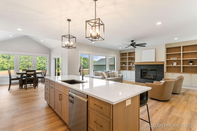 12607 76th Ave, Allendale, MI 49401 - kitchen featuring dishwasher, a sink, a fireplace, light countertops, and light wood-style floors