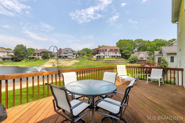 933 Meadow Ridge Dr, Holland, MI 49424 - deck with outdoor dining space, a water view, a residential view, and a lawn