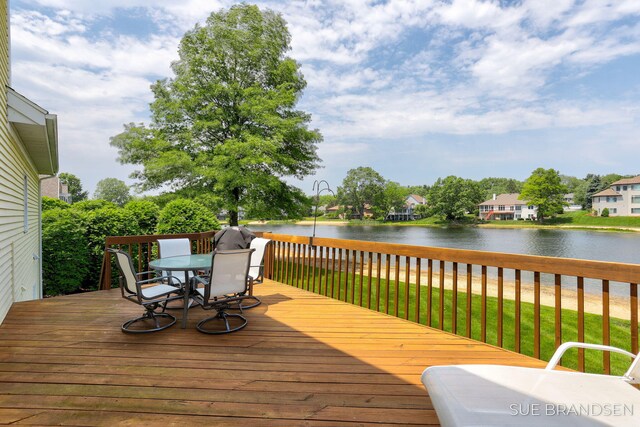 933 Meadow Ridge Dr, Holland, MI 49424 - deck featuring a water view, outdoor dining space, and a residential view