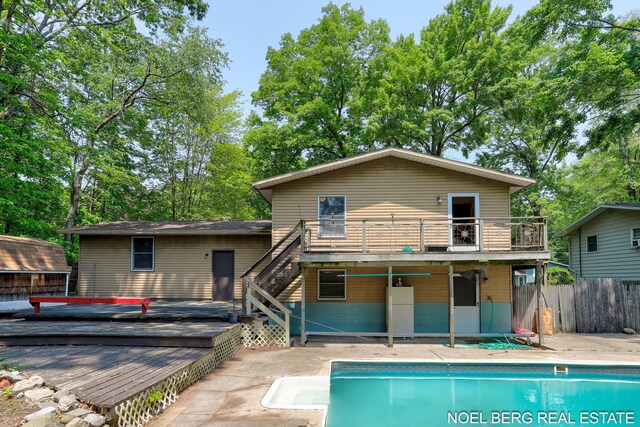 1710 Dykhouse Ave, Grand Haven, MI 49417 - rear view of house with a deck, stairs, a patio, and a balcony