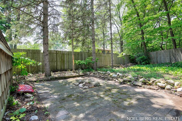 1710 Dykhouse Ave, Grand Haven, MI 49417 - fenced backyard with a patio