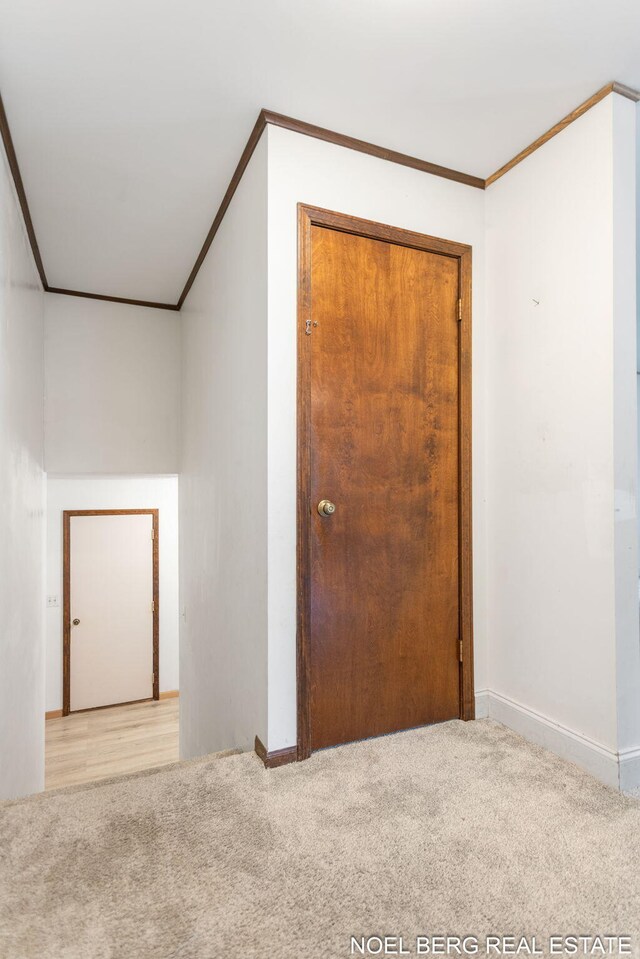 1710 Dykhouse Ave, Grand Haven, MI 49417 - empty room featuring light carpet, ornamental molding, and baseboards