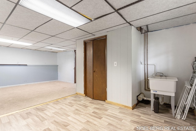1710 Dykhouse Ave, Grand Haven, MI 49417 - finished basement with wood finished floors, baseboards, a sink, and a paneled ceiling