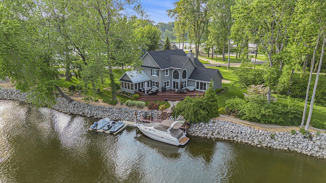 1415 Blackhawk Trl, Benton Harbor, MI 49022 - rear view of house with a chimney, a deck with water view, and a shingled roof