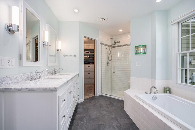 1415 Blackhawk Trl, Benton Harbor, MI 49022 - full bath with a shower stall, a garden tub, double vanity, a spacious closet, and recessed lighting