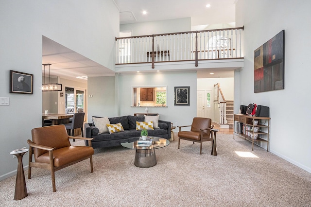 1415 Blackhawk Trl, Benton Harbor, MI 49022 - carpeted living room with stairs, a towering ceiling, recessed lighting, and a chandelier