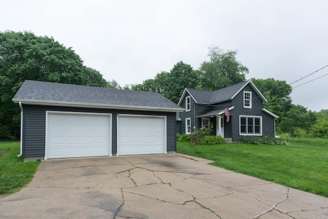 67679 Union Rd, Union, MI 49130 - traditional-style home featuring an outdoor structure, a front yard, a detached garage, and a shingled roof