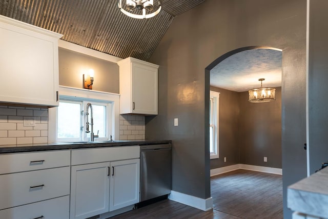 67679 Union Rd, Union, MI 49130 - kitchen with stainless steel dishwasher, lofted ceiling, dark wood-type flooring, arched walkways, and a sink
