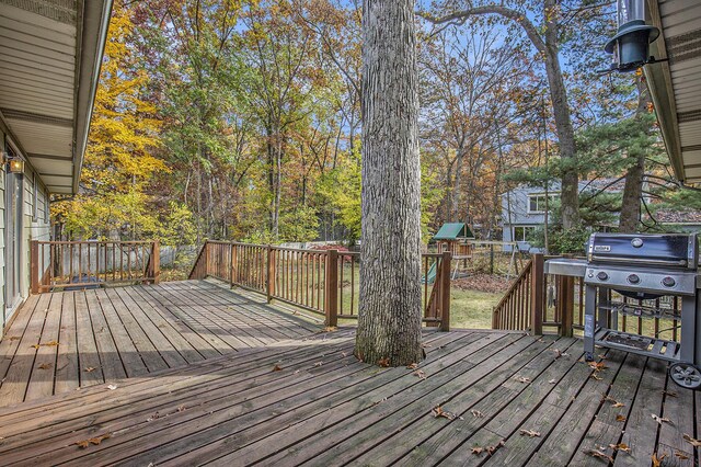 7362 30th St SE, Ada, MI 49301 - wooden deck with a playground and a grill