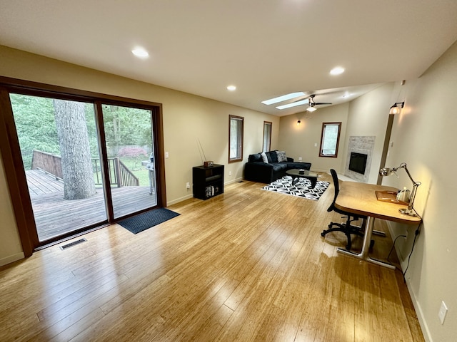 7362 30th St SE, Ada, MI 49301 - office featuring light wood-type flooring, a fireplace, ceiling fan, and recessed lighting