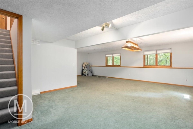 9057 Vergennes St SE, Ada, MI 49301 - below grade area featuring carpet, baseboards, stairs, and a textured ceiling