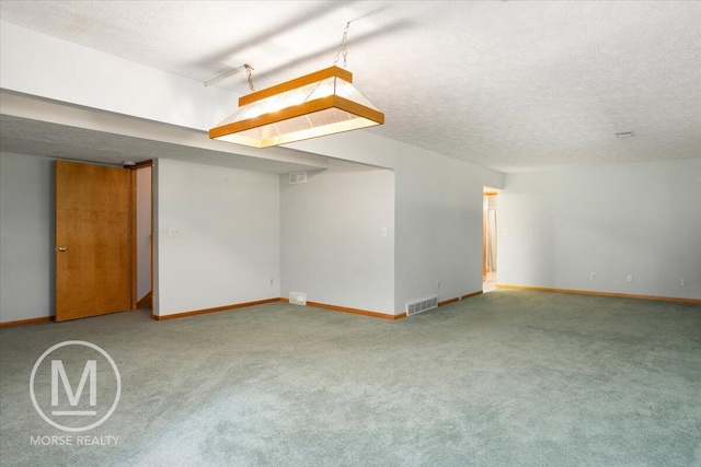 9057 Vergennes St SE, Ada, MI 49301 - unfurnished room featuring carpet floors, baseboards, and a textured ceiling