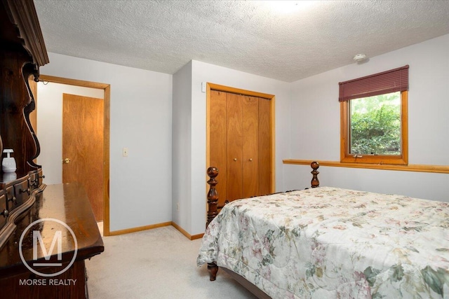 9057 Vergennes St SE, Ada, MI 49301 - bedroom with a closet, carpet flooring, a textured ceiling, and baseboards