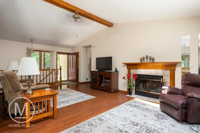 9057 Vergennes St SE, Ada, MI 49301 - living room with wood finished floors, a tiled fireplace, and baseboards
