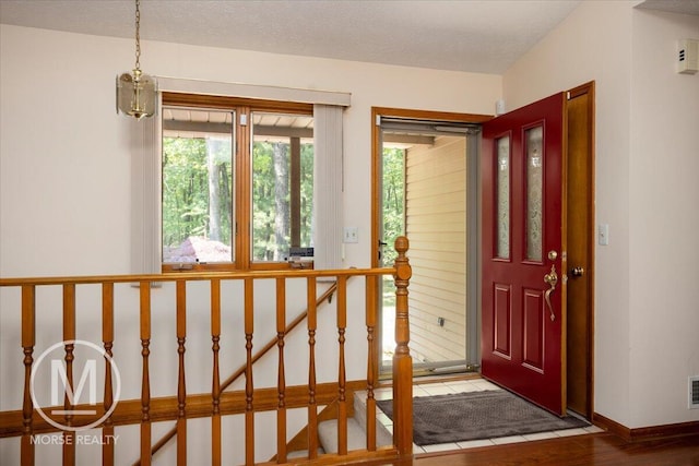 9057 Vergennes St SE, Ada, MI 49301 - entrance foyer featuring wood finished floors and baseboards