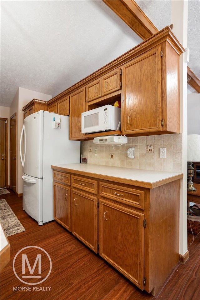 9057 Vergennes St SE, Ada, MI 49301 - kitchen featuring white appliances, dark wood finished floors, backsplash, and light countertops