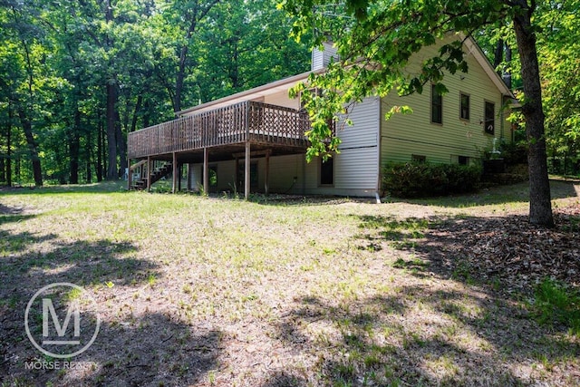 9057 Vergennes St SE, Ada, MI 49301 - rear view of house featuring stairway, a deck, a lawn, and a chimney