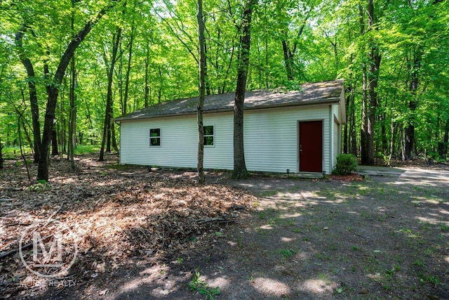 9057 Vergennes St SE, Ada, MI 49301 - view of outdoor structure featuring a forest view