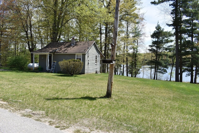 226 N 176th Ave, Walkerville, MI 49459 - view of side of home with a chimney, a yard, and a water view