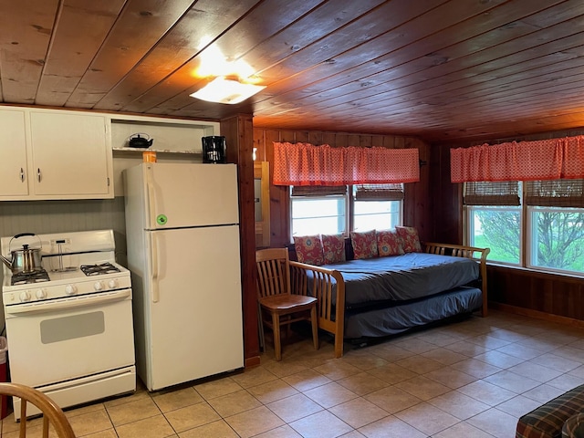 226 N 176th Ave, Walkerville, MI 49459 - bedroom with freestanding refrigerator, multiple windows, light tile patterned floors, wood ceiling, and wood walls