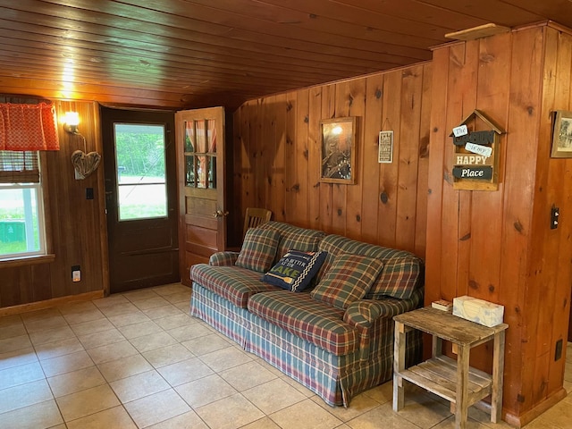 226 N 176th Ave, Walkerville, MI 49459 - living room featuring light tile patterned floors, wood walls, wooden ceiling, and baseboards