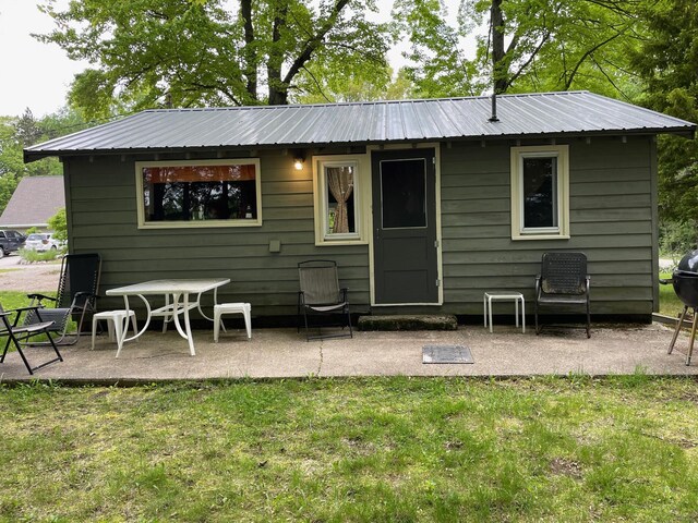 226 N 176th Ave, Walkerville, MI 49459 - rear view of property with metal roof, a patio, and a yard