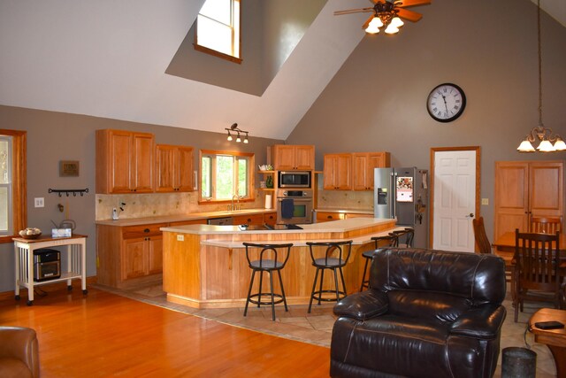 226 N 176th Ave, Walkerville, MI 49459 - living room featuring high vaulted ceiling, light wood-type flooring, ceiling fan, and a chandelier