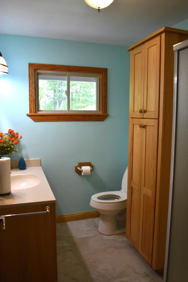 226 N 176th Ave, Walkerville, MI 49459 - bathroom featuring vanity, toilet, a stall shower, and baseboards