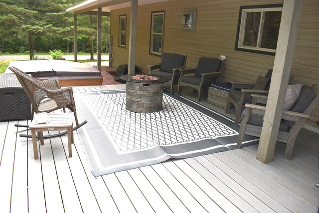 226 N 176th Ave, Walkerville, MI 49459 - wooden deck with a covered hot tub and a fire pit