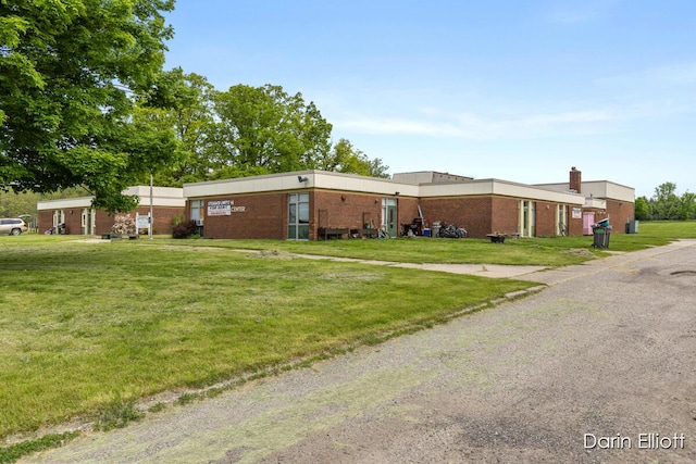 306 W Russell St, Hubbardston, MI 48845 - view of front of house featuring a front lawn and brick siding