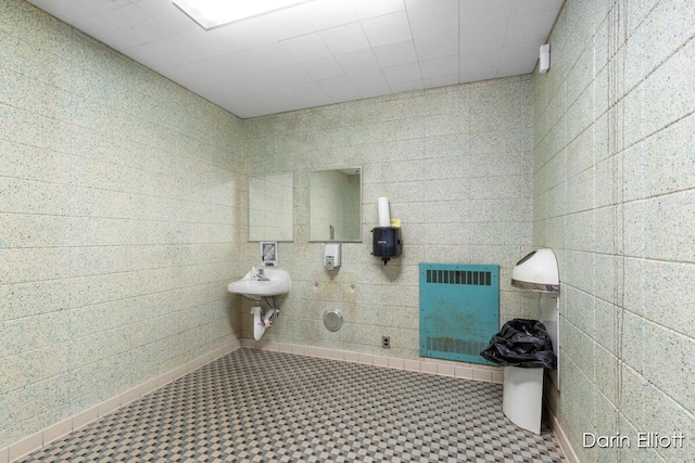 306 W Russell St, Hubbardston, MI 48845 - bathroom featuring heating unit and tile patterned floors