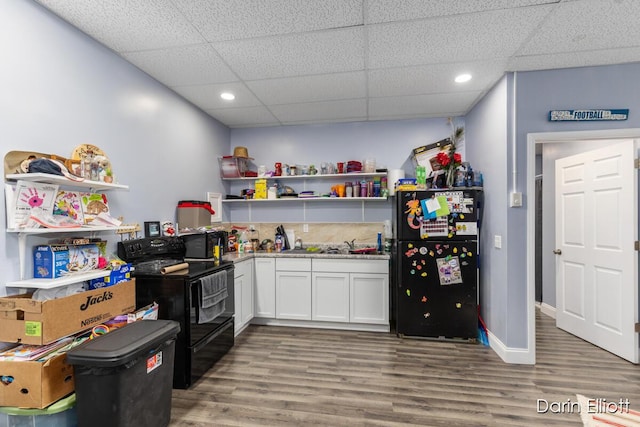 306 W Russell St, Hubbardston, MI 48845 - bar with black appliances, a drop ceiling, wood finished floors, recessed lighting, and a sink