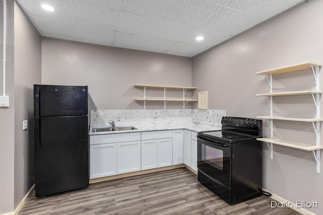 306 W Russell St, Hubbardston, MI 48845 - kitchen with black appliances, open shelves, a sink, wood finished floors, and recessed lighting