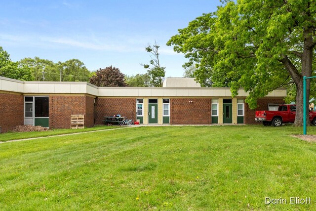 306 W Russell St, Hubbardston, MI 48845 - back of property featuring a yard and brick siding