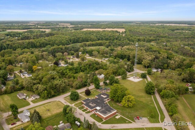 306 W Russell St, Hubbardston, MI 48845 - aerial overview of property's location with a heavily wooded area
