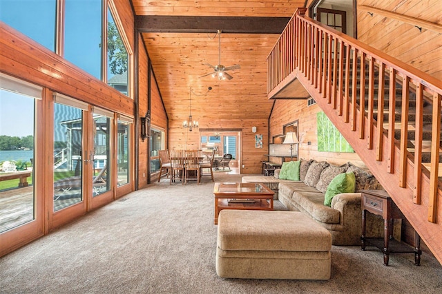 8994 Lenhards Lndg, Clarksville, MI 48815 - carpeted living room with high vaulted ceiling, wooden ceiling, a ceiling fan, wood walls, and a chandelier
