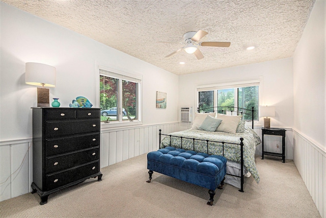 8994 Lenhards Lndg, Clarksville, MI 48815 - carpeted bedroom featuring a wainscoted wall, a textured ceiling, ceiling fan, recessed lighting, and a decorative wall