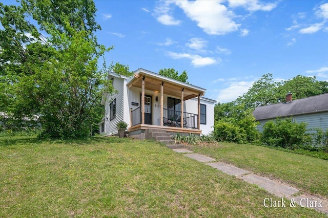 820 Hackett St, Ionia, MI 48846 - view of front facade featuring a porch and a front lawn