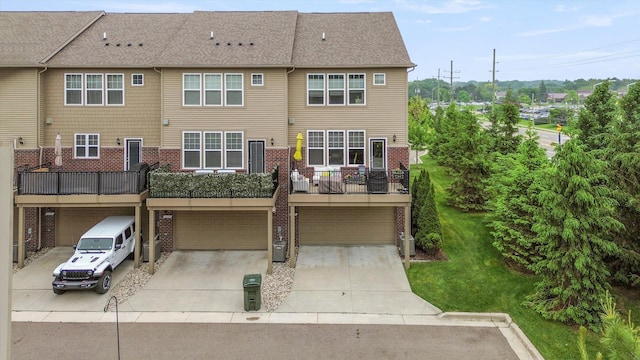 2605 Helmsdale Cir, Rochester, MI 48307 - back of house featuring an attached garage, brick siding, driveway, and a yard