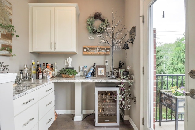 2605 Helmsdale Cir, Rochester, MI 48307 - indoor dry bar featuring beverage cooler, dark wood-style flooring, and baseboards