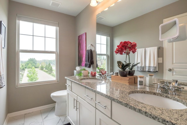 2605 Helmsdale Cir, Rochester, MI 48307 - bathroom featuring baseboards, double vanity, marble look tile flooring, and toilet