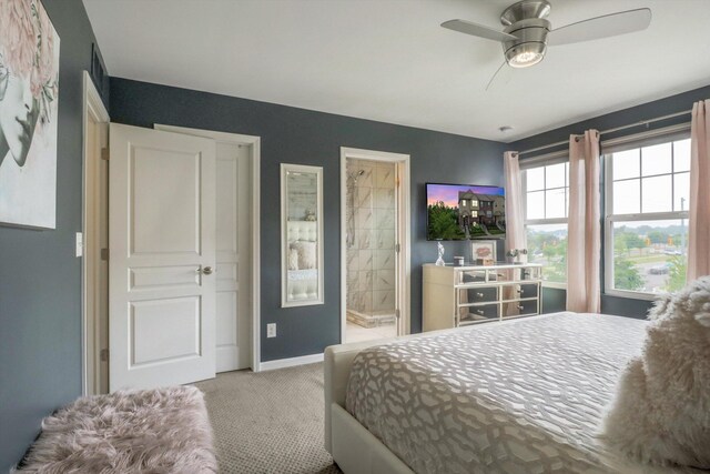 2605 Helmsdale Cir, Rochester, MI 48307 - bedroom featuring carpet, baseboards, ensuite bath, and ceiling fan