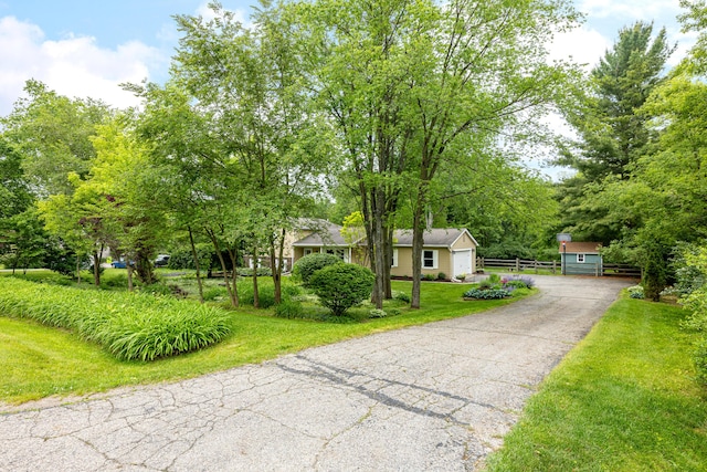 9177 Horseshoe Bnd, Dexter, MI 48130 - view of front of home with asphalt driveway, a front lawn, and a garage