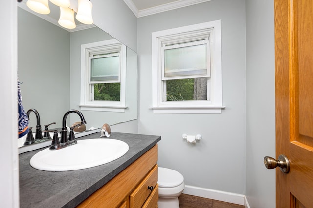 9177 Horseshoe Bnd, Dexter, MI 48130 - bathroom with ornamental molding, vanity, toilet, baseboards, and wood finished floors