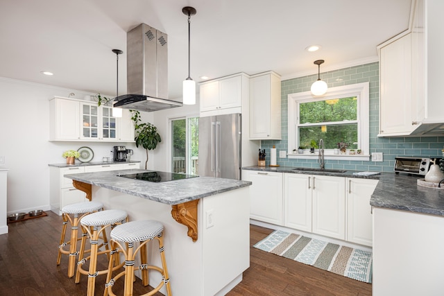 9177 Horseshoe Bnd, Dexter, MI 48130 - kitchen featuring island exhaust hood, high end fridge, black electric stovetop, a sink, and a center island