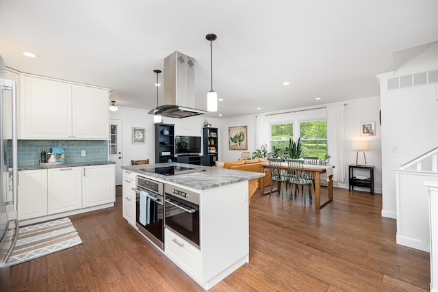 9177 Horseshoe Bnd, Dexter, MI 48130 - kitchen featuring island exhaust hood, oven, dark wood-type flooring, white cabinets, and a center island