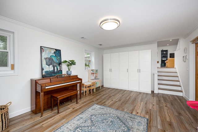 9177 Horseshoe Bnd, Dexter, MI 48130 - living area featuring crown molding, light wood finished floors, stairway, healthy amount of natural light, and baseboards
