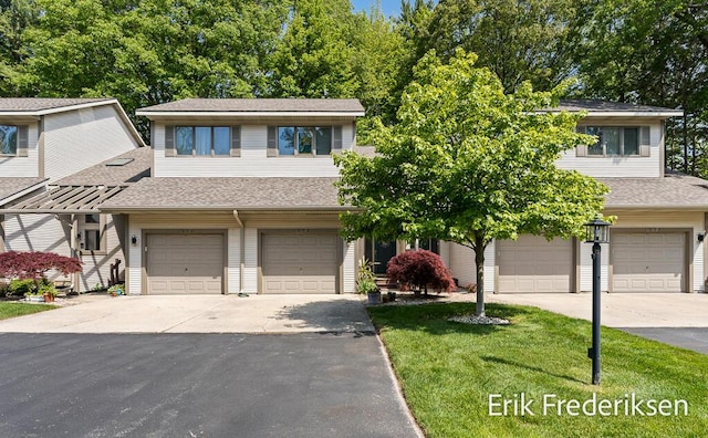 17879 Hidden Dunes Ln Unit D, Spring Lake, MI 49456 - view of front of property featuring an attached garage, asphalt driveway, roof with shingles, and a front yard